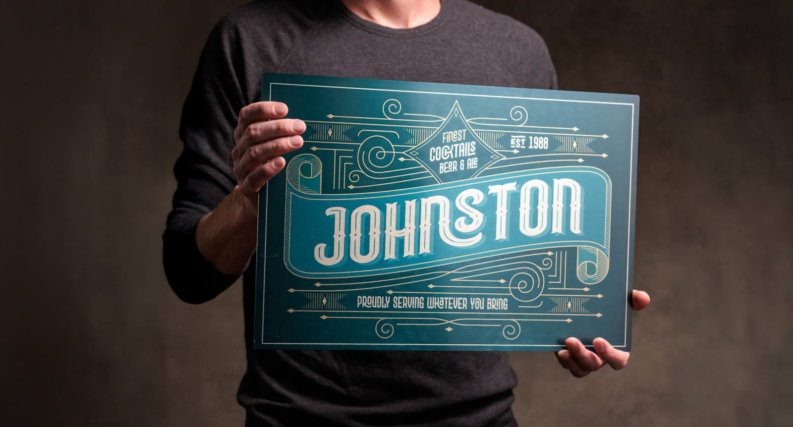 Man holding a personalized metal sign from Man Crates